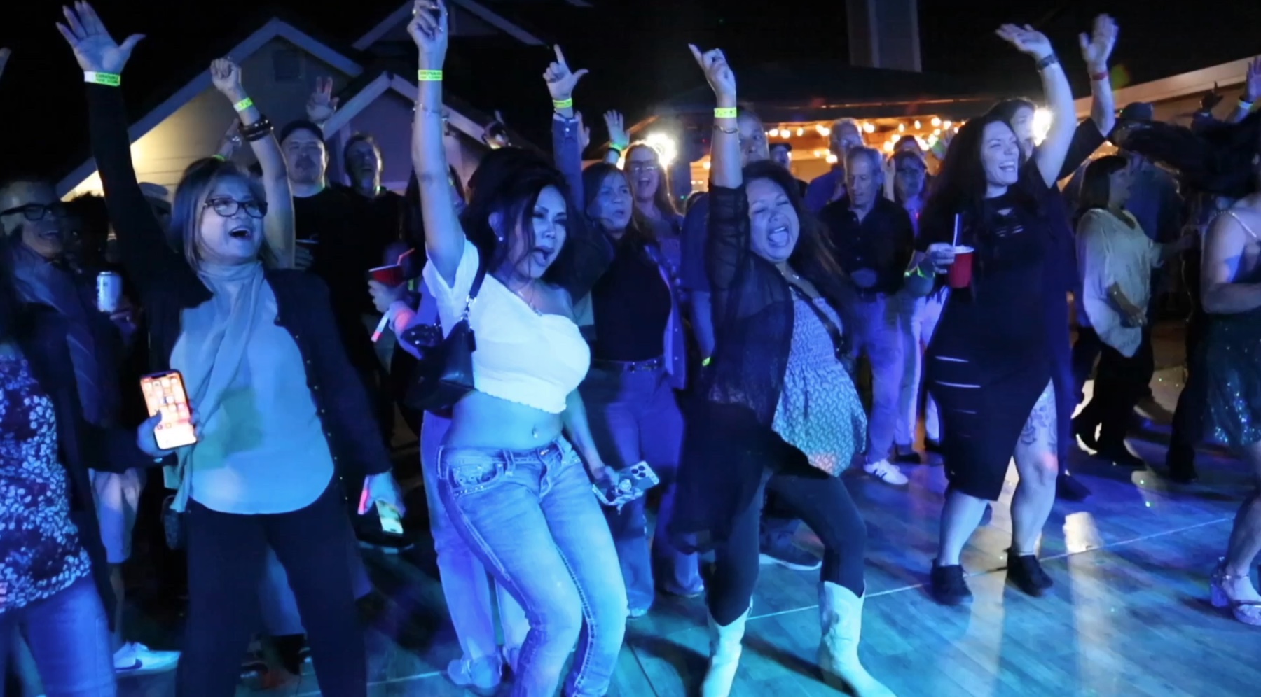Guests cheering together on the dance floor