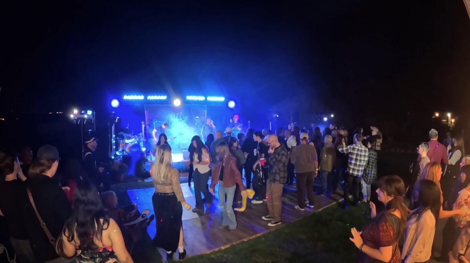 Guests filling the dance floor in front of the band