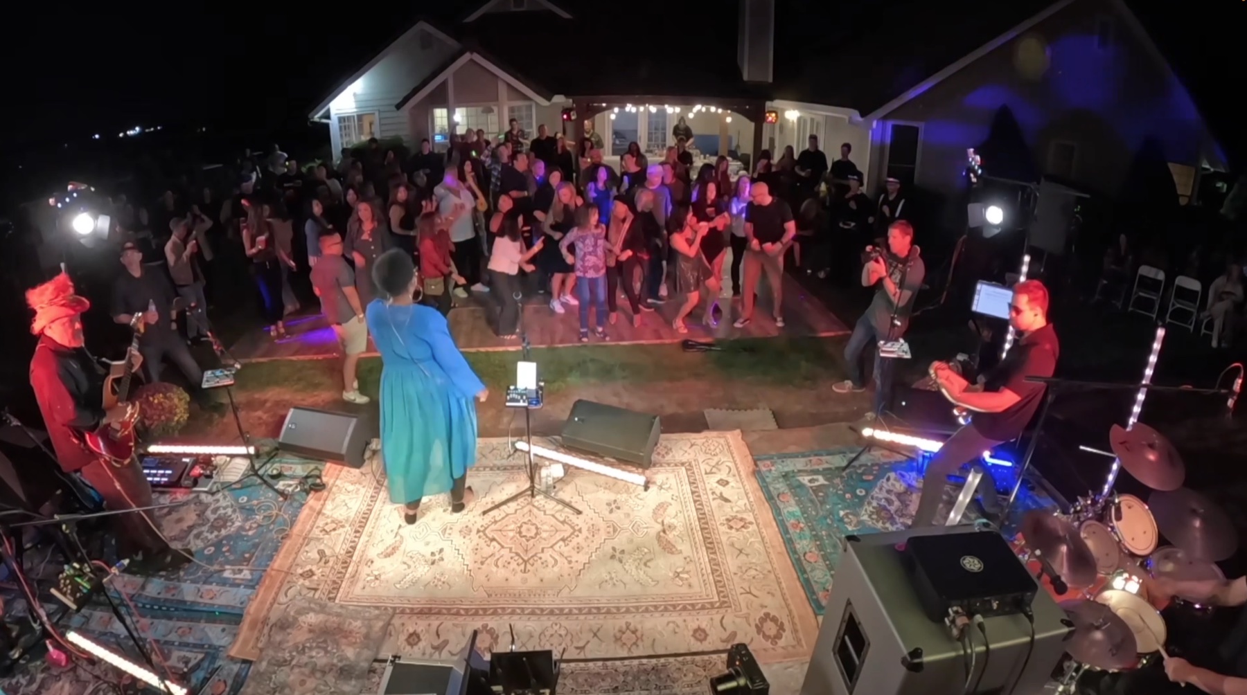 View from the stage toward a full dance floor and patio