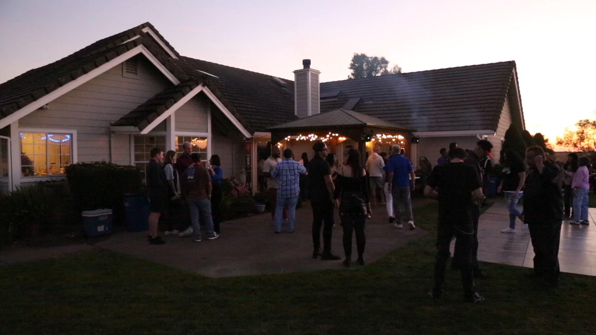 Guests gathering around the house and patio