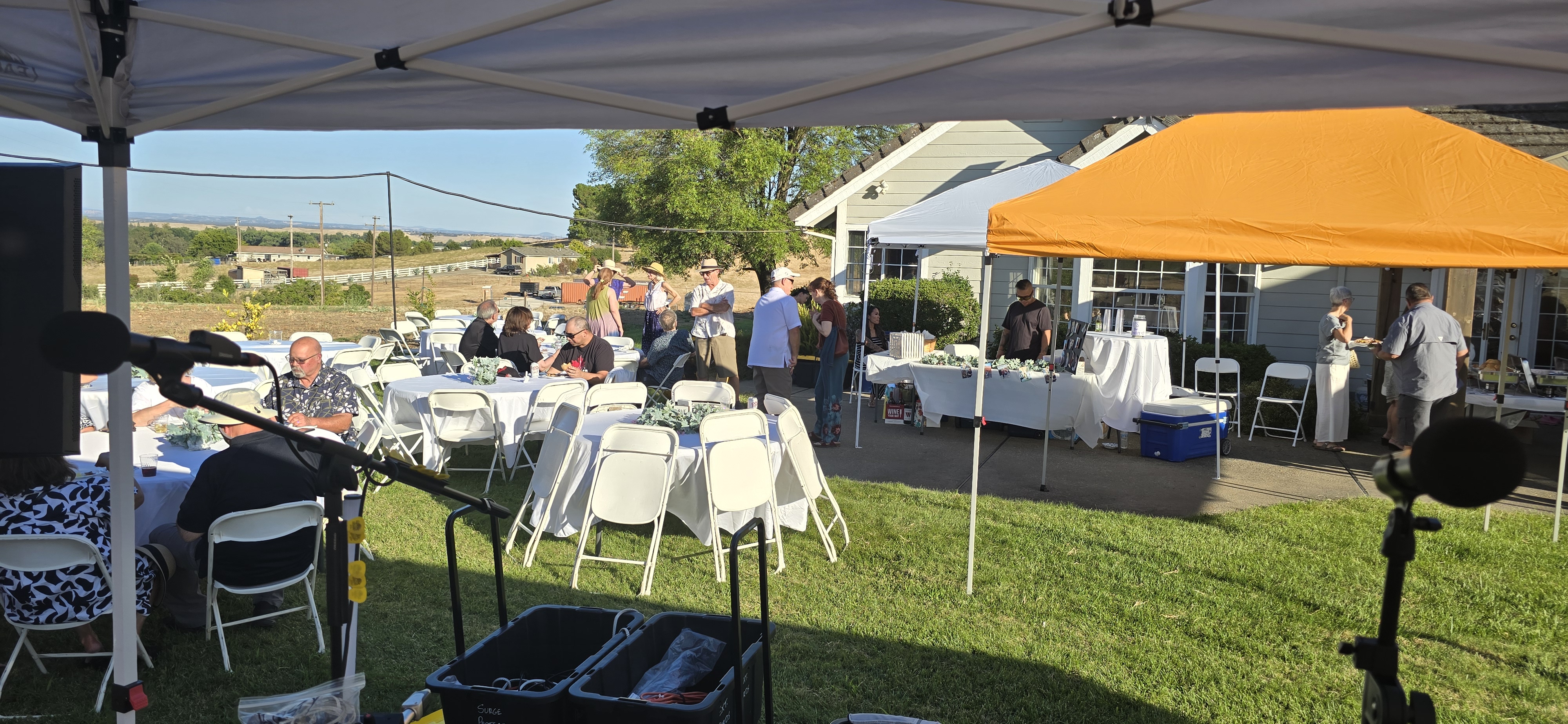 White-covered reception tables arranged across the lawn at Amber Ranch