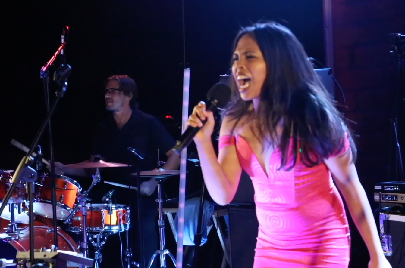Sofia singing lead with All Good Vibes in her pink dress